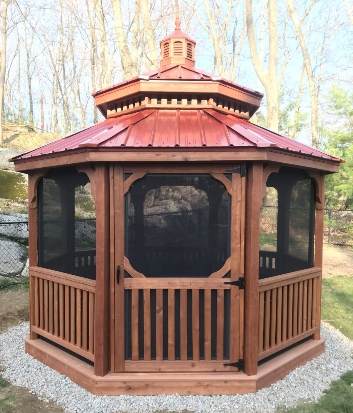 12' Octagon Wood, Standard Rails, Straight Fascia, No Top Rails, Pagoda Roof, Red Metal Roof, Screen Package, Cedar Stain